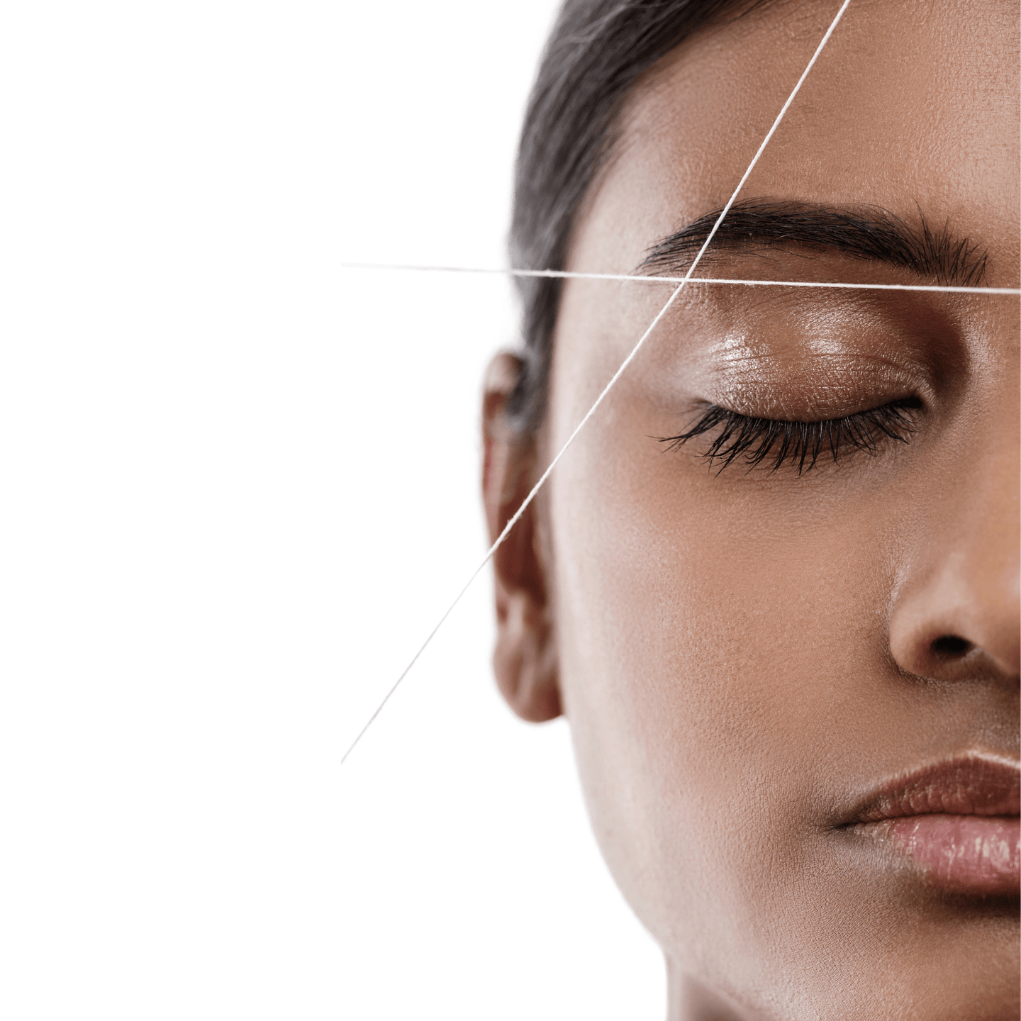 Close-up of professional eyebrow threading with cotton thread